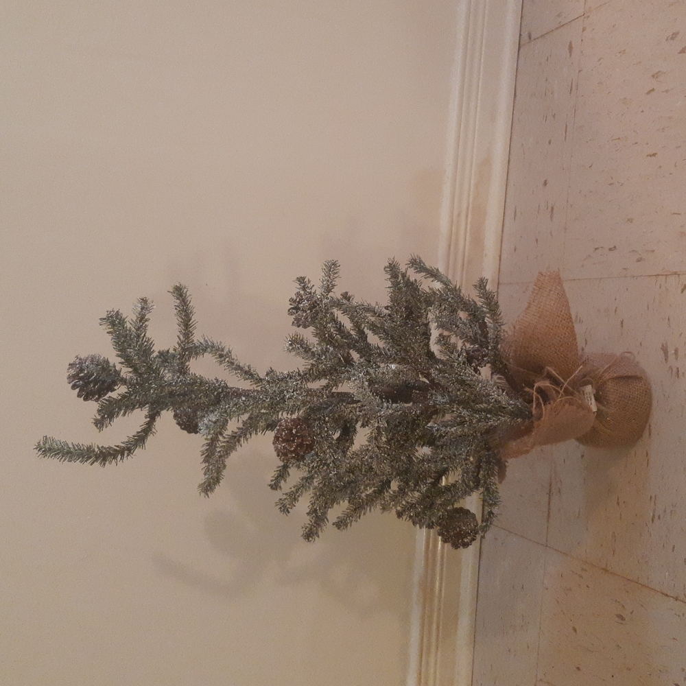 Artificial Christmas tree with snow and pinecones table top